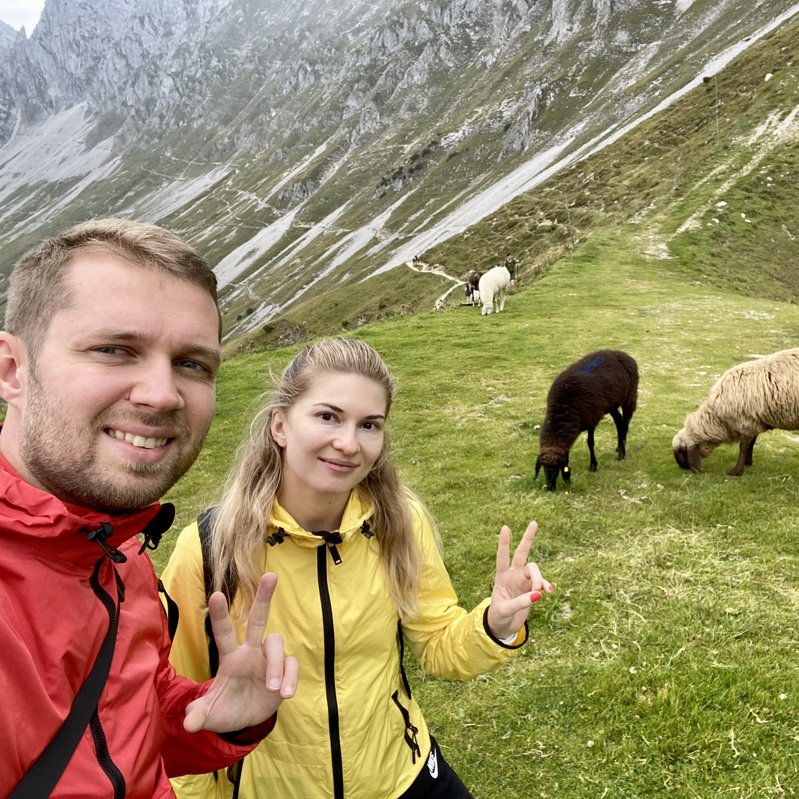 Denis and Julia hiking with sheep in the Alps
